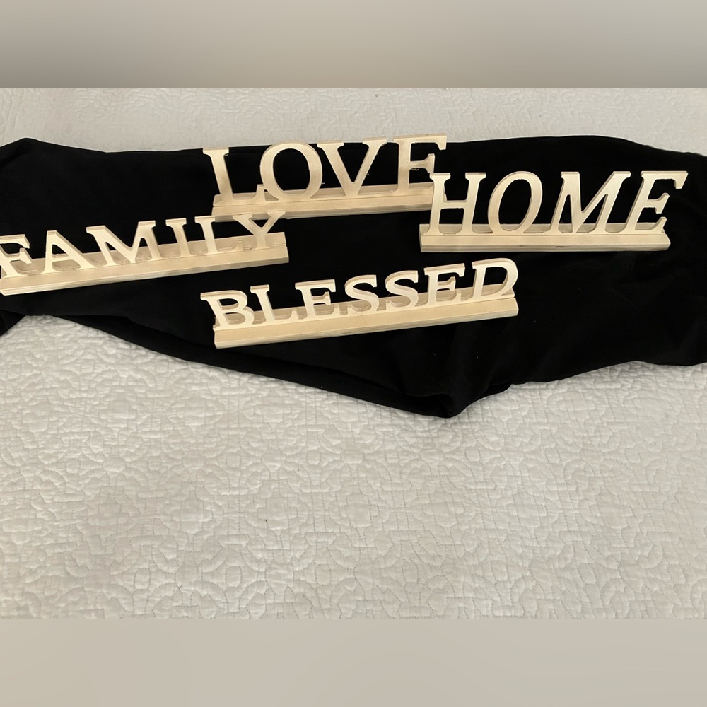 Four WoodCutOut Words: Family, Home, Love, Blessed. Cream color unfinished wood.